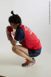 Sportswear Woman Asian Kneeling poses - ALL Average Kneeling poses - on one knee medium black Fighting Standard Photoshoot Academic